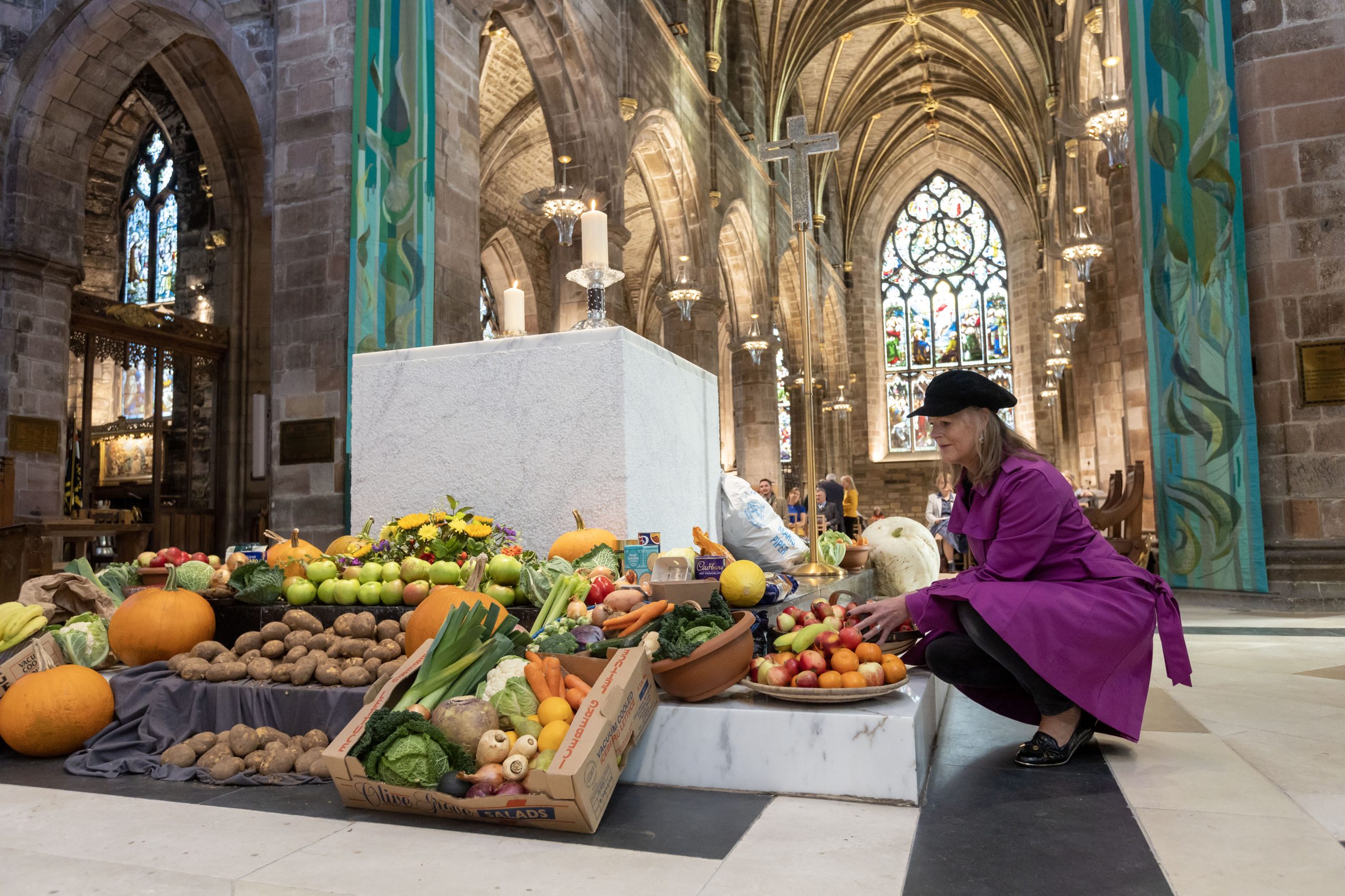 A lady sorting the fruit and vegetable display in St Giles' Cathedra